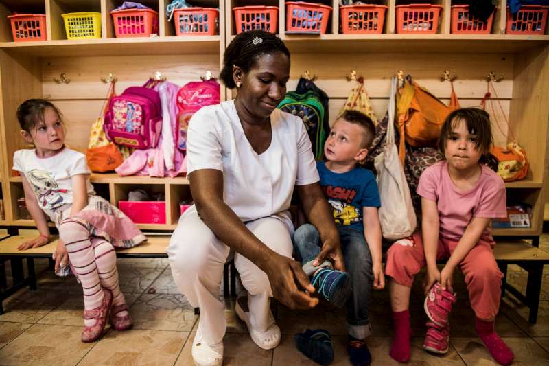 Sophie, 30, takes care of children in the kindergarten where she works in Budapest, Hungary. Sophie, 30, fled her native Togo in West Africa to avoid forced female genital mutilation. She was recognized as a refugee in 2004 and has twin boys, aged 10, and a daughter, seven, all born in Hungary. She says she has lost all touch with her family in Togo and would like to become a Hungarian citizen – but her application has been rejected twice.